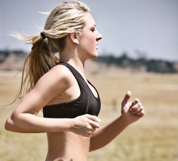 Młoda wysportowana kobieta biegnąca w stroju sportowym
